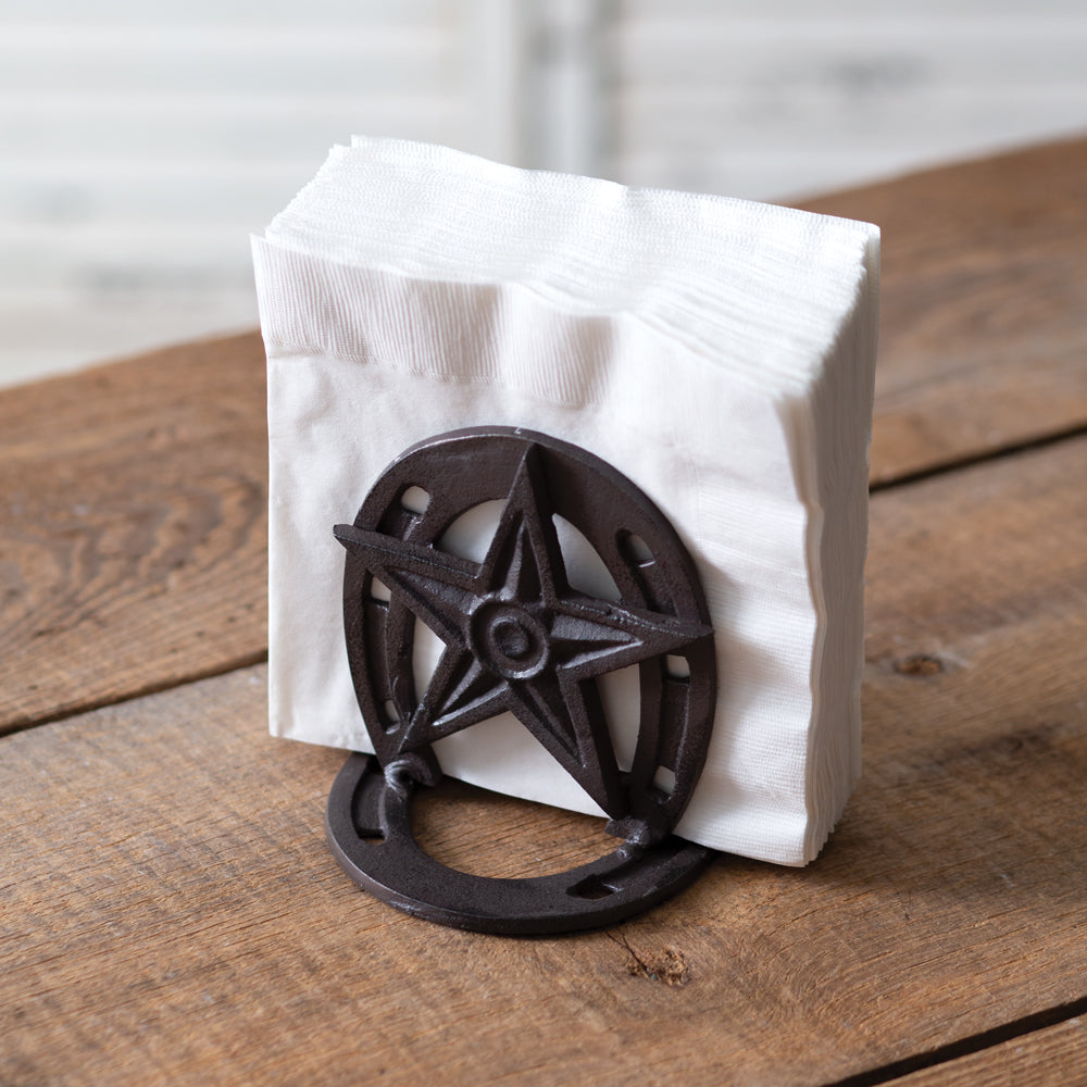 Cast iron napkin holder with a western theme, featuring cowboy and horse motifs, perfect for rustic dining table decor.