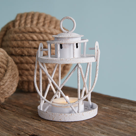 Lighthouse tealight holder with a coastal theme, crafted from durable metal, emits a warm glow, perfect for ocean lovers.