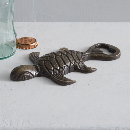 Sea turtle-shaped cast iron bottle opener with intricate details, perfect for adding a whimsical touch to your kitchen or bar.