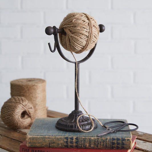 A vintage-inspired twine holder with scissors, featuring a spindle design, perfect for adding charm to craft rooms or garden sheds.