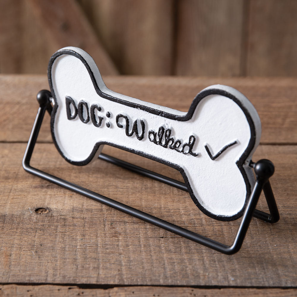 Cast iron rotating tabletop sign with "Dog Needs A Walk" and "Dog Walked" text, adding charm and functionality to home decor.