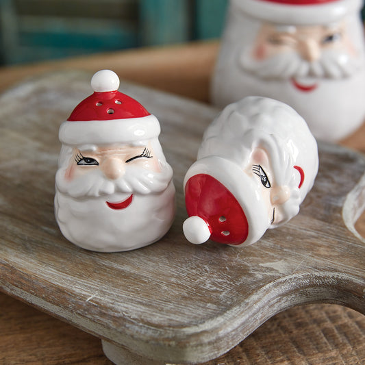 Winking Santa salt and pepper shakers with Santa's playful expression, crafted from dolomite, perfect for festive dining.