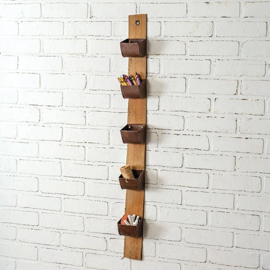 Hanging utility belt organizer with five metal pockets, neatly arranged on a wall, showcasing its sleek and practical design.