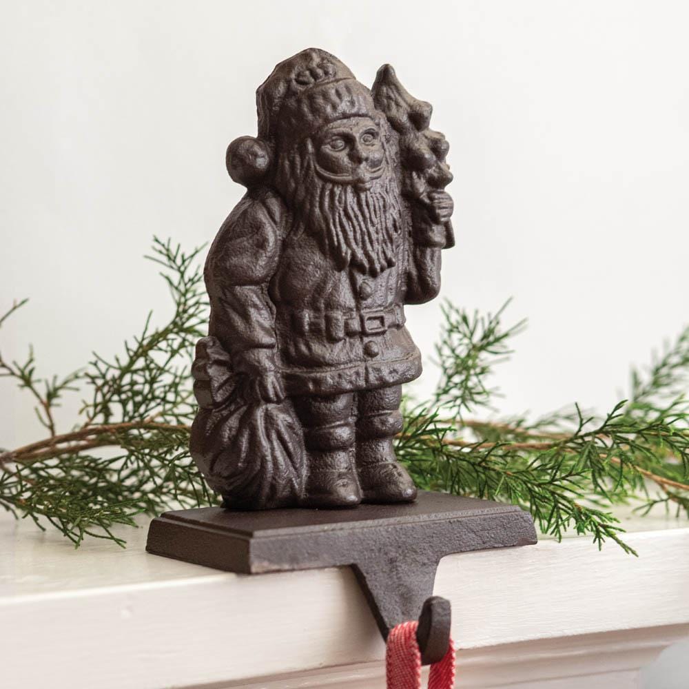 Cast iron Santa stocking holder with a rustic design, perfect for securely holding stockings on a festive mantel.