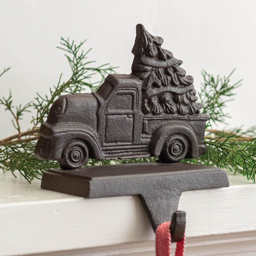 Cast iron truck with a festive tree on top, perfect for adding rustic charm to your holiday mantel decor.