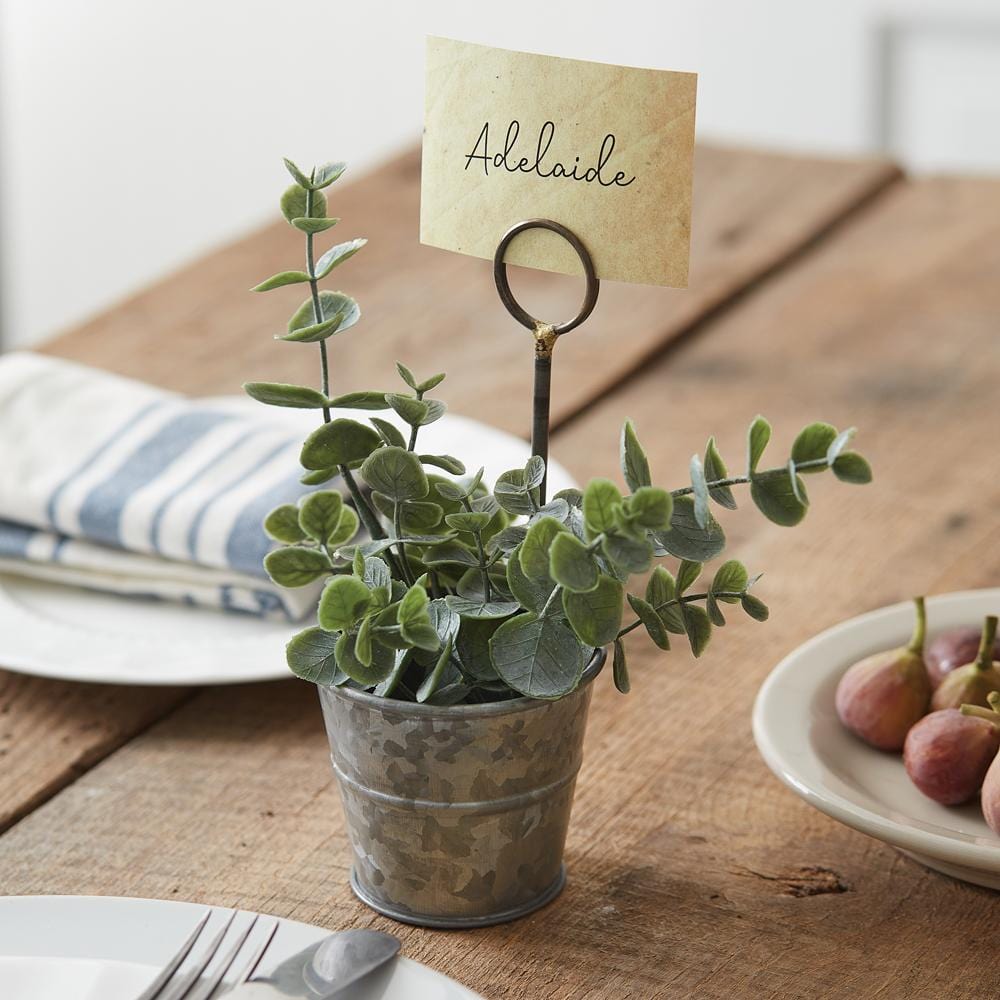 A charming galvanized metal pail placecard holder, perfect for organizing cards with a rustic and elegant touch.