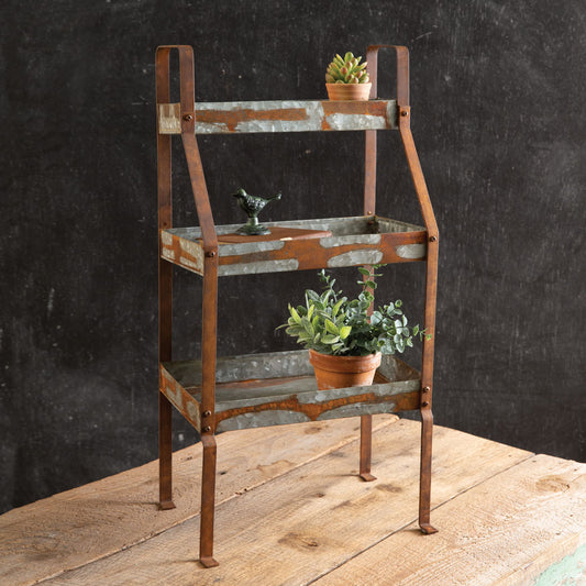 Rustic metal three-tier caddy with two large and one small shelf, ideal for farmhouse decor or displaying plants.