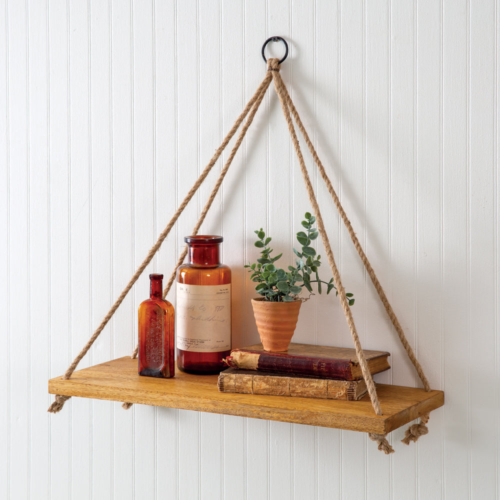 Boho chic wooden wall shelf with twine ropes, displaying small plants and decor, adding warmth and character to any room.