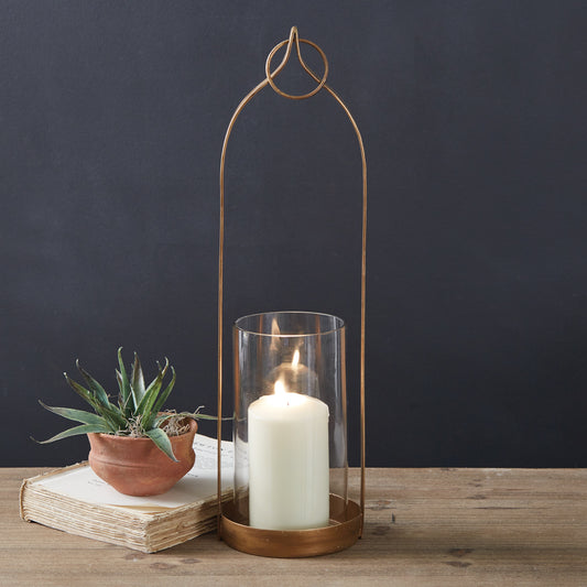 Brass-plated lantern with open area and chimney, perfect for candles. Features a top loop for hanging, adding elegance to decor.