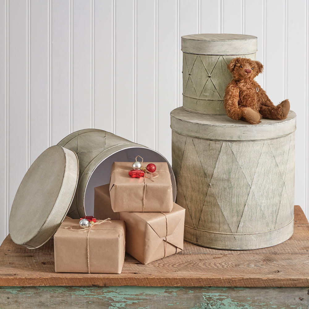 Set of three vintage-finished metal drum tins, varying in size, stacked together showcasing their elegant and practical design.