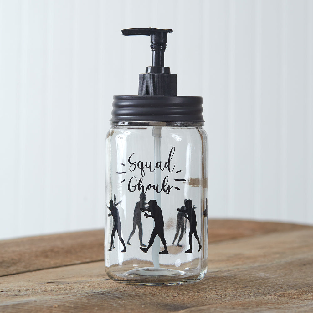 Clear glass soap dispenser with black pumper, featuring marching zombies and "Squad Ghouls" text for a spooky, fun touch.