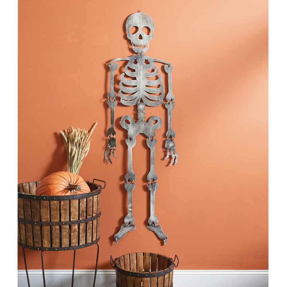 Eerie metal skeleton hanging on a wall, perfect for Halloween decor, with a loop on its head for easy display.