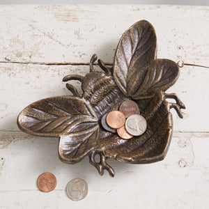 A pair of antique brass trinket dishes with a honey bee motif, perfect for holding small items and enhancing home decor.