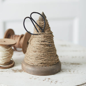 Vintage-style spindle twine holder with scissors, perfect for decor and utility in craft rooms or garden sheds.