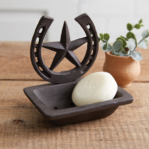 Rustic cast iron soap dish with star and horseshoe design, featuring drain holes for easy cleaning, perfect for western decor.