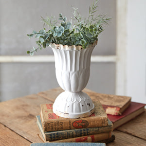 A small scalloped vase in soft white with rustic edges, perfect for French country decor, holding fresh cut flowers.