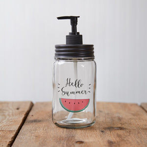 Clear glass soap dispenser with a black pump, perfect for summer decor in kitchens or bathrooms, holds one pint of liquid.