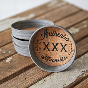 Set of four round coasters with a unique moonshine print, featuring a cork interior for moisture absorption and durable design.