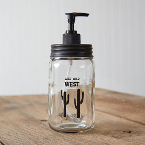 Clear glass soap dispenser with a sleek black pump, perfect for adding a touch of Wild West charm to your bathroom or kitchen.