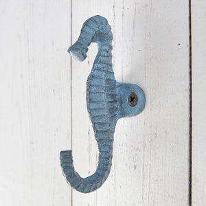 Seafoam-colored cast iron seahorse hooks, set of 2, perfect for coastal decor; ideal for hanging towels, robes, or aprons.